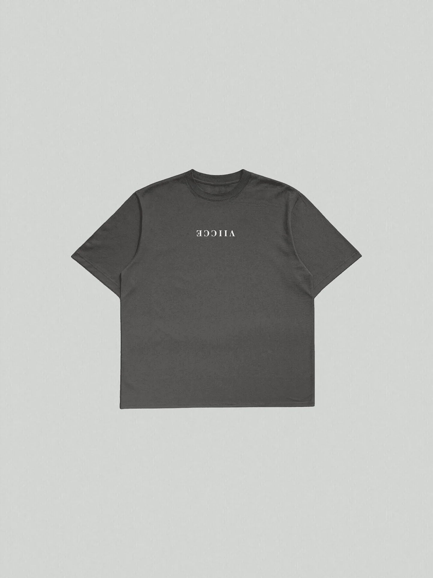 Essence Tee - Vintage Black Oversized. T-shirt with a floor-lay design facing the front and "Viicce" written in reverse on the chest. Made with high-quality organic cotton. Studio photo.