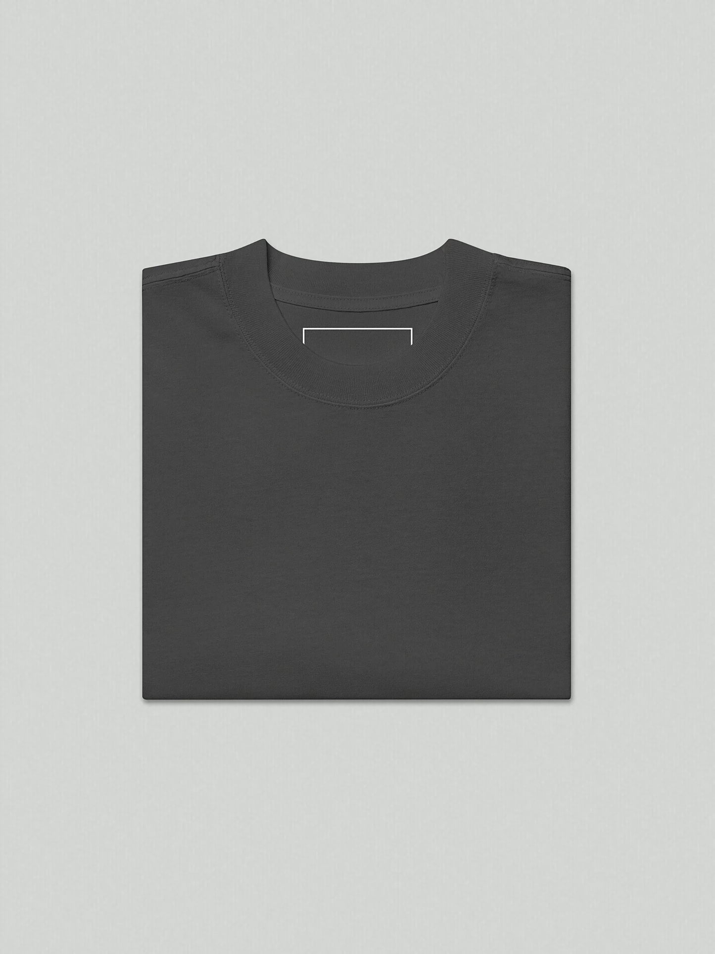 A flat lay image of the VIICCE 240 GSM carded cotton t-shirt in faded grey, highlighting the wide neck ribbing and oversized silhouette.