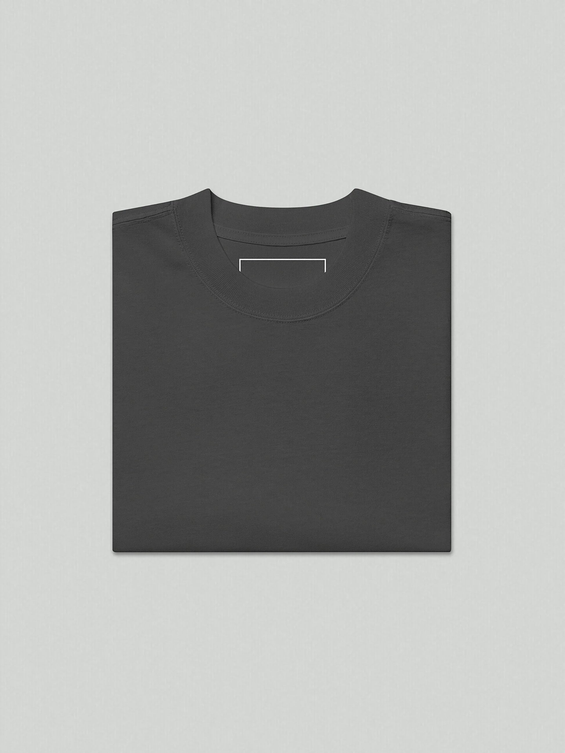 A flat lay image of the VIICCE 240 GSM carded cotton t-shirt in faded grey, highlighting the wide neck ribbing and oversized silhouette.
