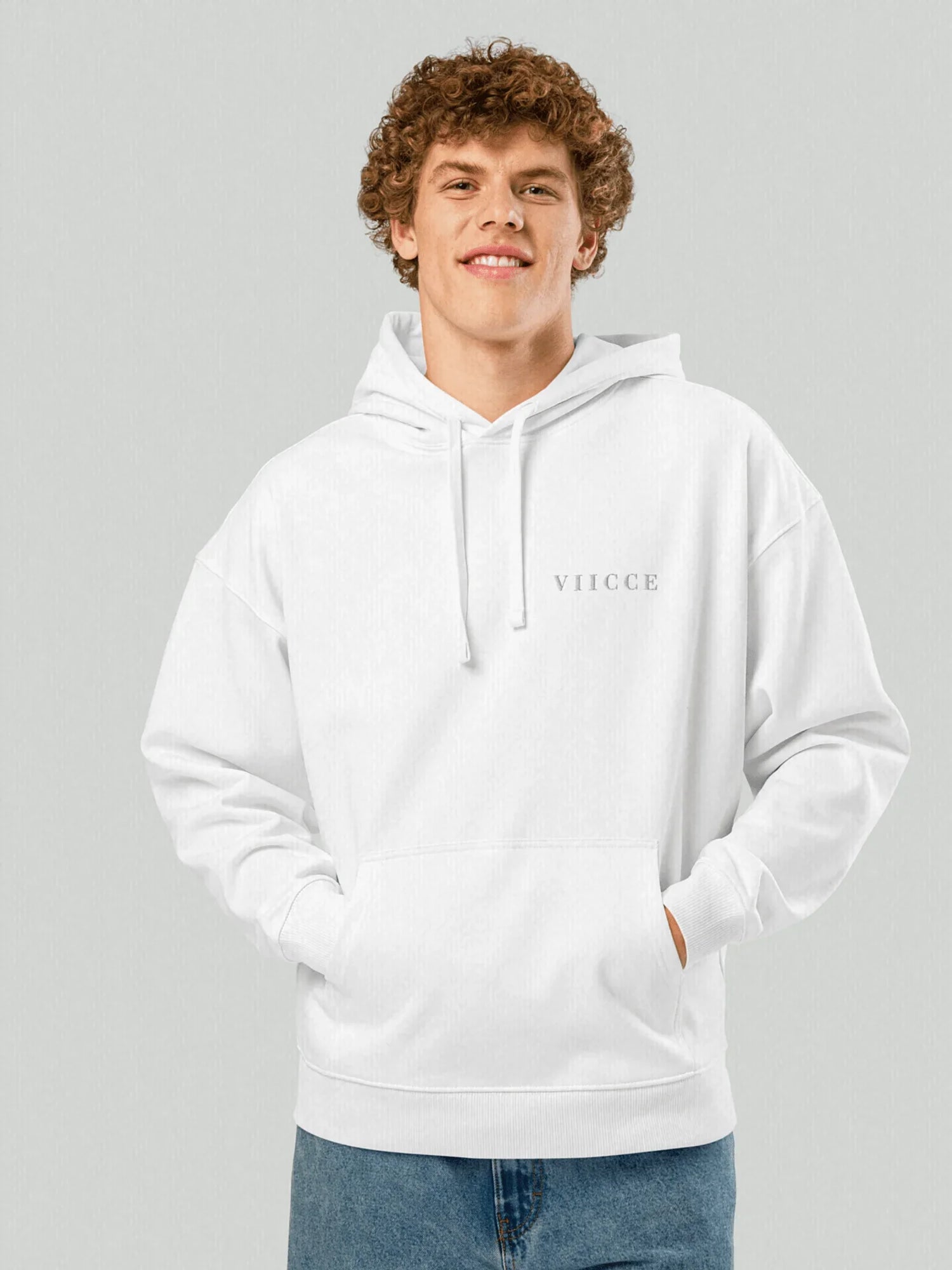 Male model wearing VIICCE Cloud Hoodie in white heavyweight cotton featuring an oversized fit and minimalist chest logo