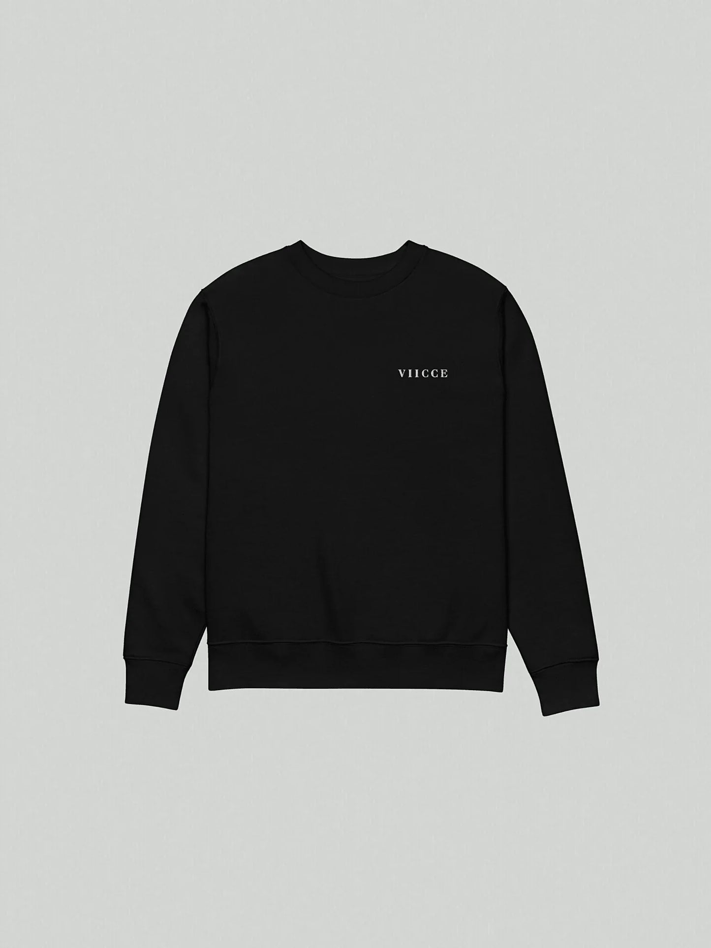 Flat lay of the Core Heavyweight Sweatshirt | Jet Black isolated on a grey background. Shows the front of the garment with a reinforced crew neck and minimalist logo on the chest. Clean design and heavyweight construction.