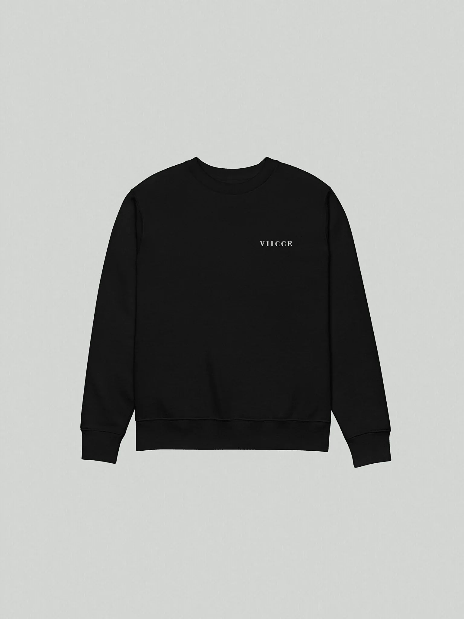 Flat lay of the Core Heavyweight Sweatshirt | Jet Black isolated on a grey background. Shows the front of the garment with a reinforced crew neck and minimalist logo on the chest. Clean design and heavyweight construction.