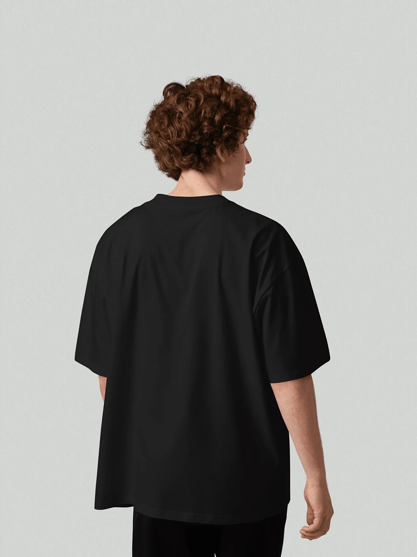 Essence Tee - Pure Black. Men's t-shirt with a boxy cut and oversized back. Made from high-quality, heavyweight organic cotton. Studio photo.