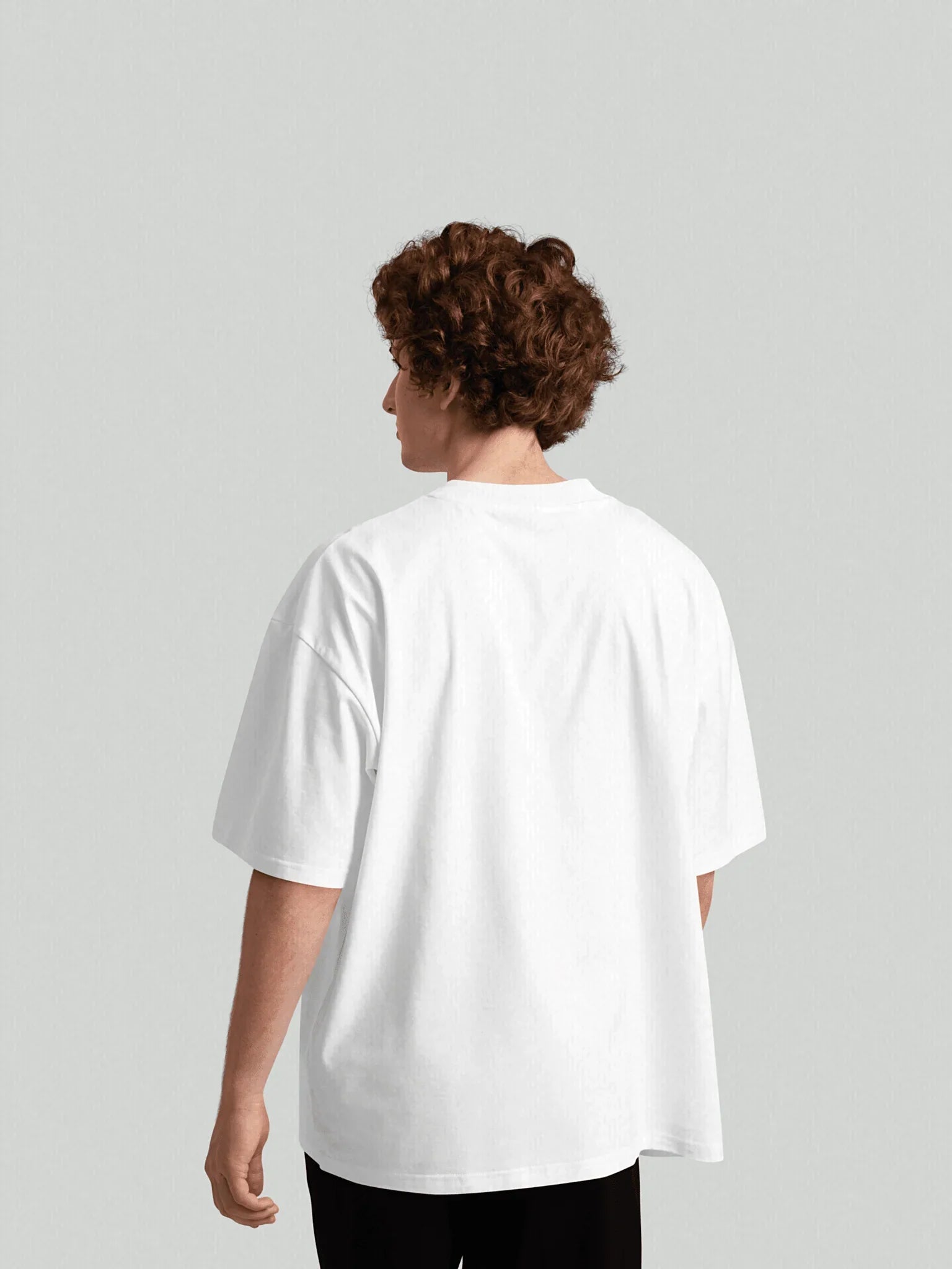 Back view of male model wearing VIICCE Essence Tee in pure white organic cotton featuring a relaxed oversized fit and fluid drape