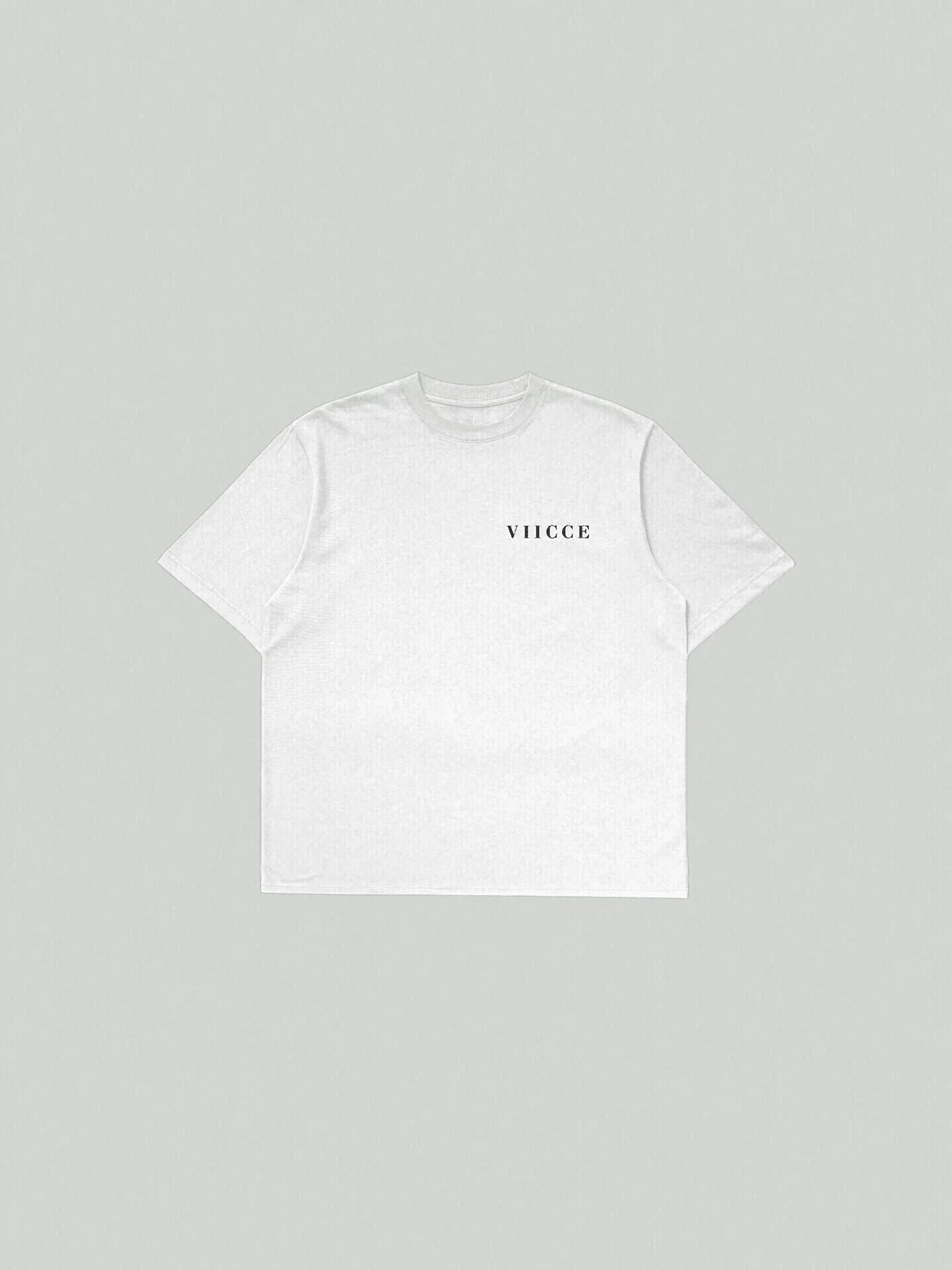 Flat lay view of VIICCE Essence Tee in pure black organic cotton featuring an oversized fit and minimalist centered logo