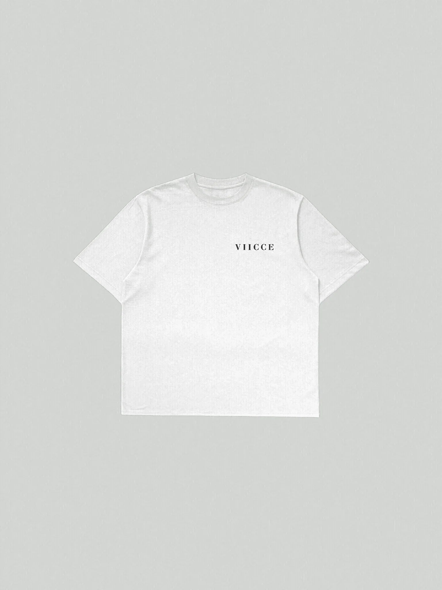 Flat lay view of VIICCE Essence Tee in pure black organic cotton featuring an oversized fit and minimalist centered logo