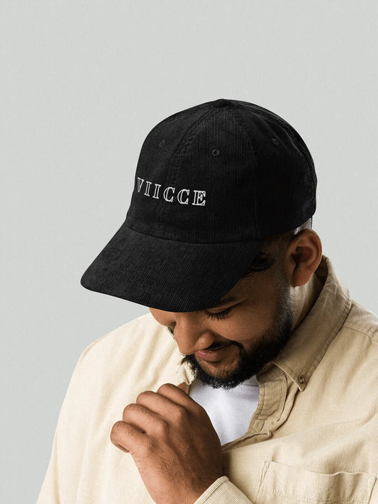 Man wearing a black VIICCE cap, modern and casual streetwear outfit