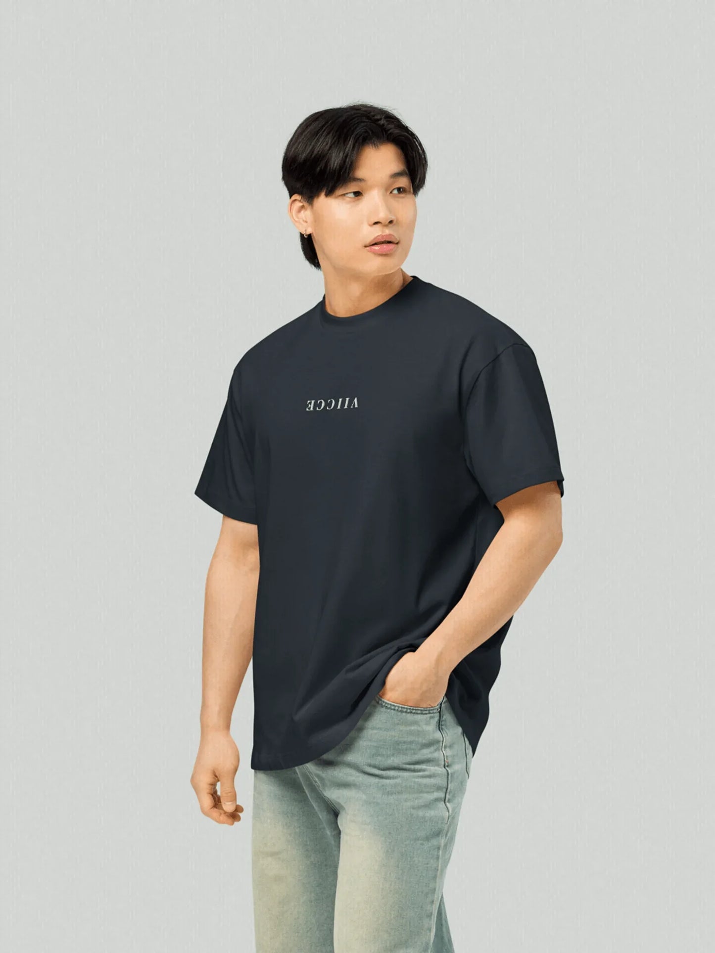 Origin Tee - Navy Oversized Blazer. Front model with oversized T-shirt with viicce written upside down on the chest. Made from high-quality organic cotton. Studio photo.