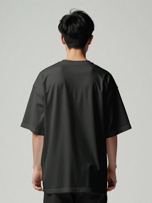 Signature Box Tee - Black Oversized. Man from behind. Made with high-quality heavyweight organic cotton. Studio photo.