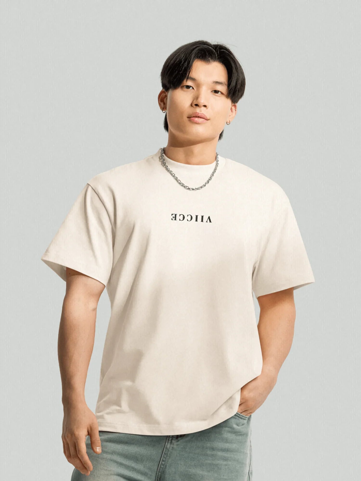 Starlight Tee - Vintage White. Front model with VIICCE written on the front in reverse. Made with high-quality organic cotton. Studio photo.