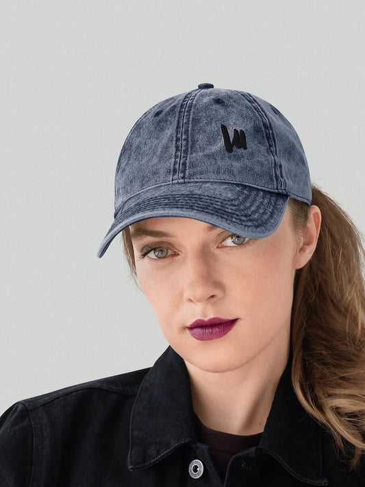 Female model wearing a navy blue VIICCE vintage cap in a casual streetwear look