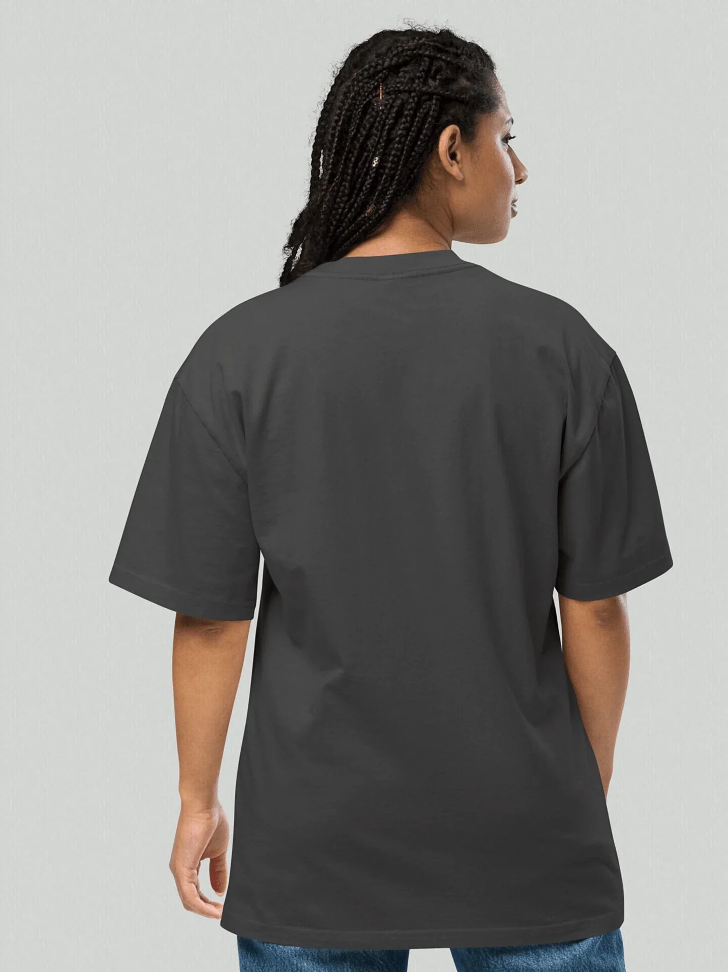 Female model wearing an oversized faded VIICCE T-shirt from behind