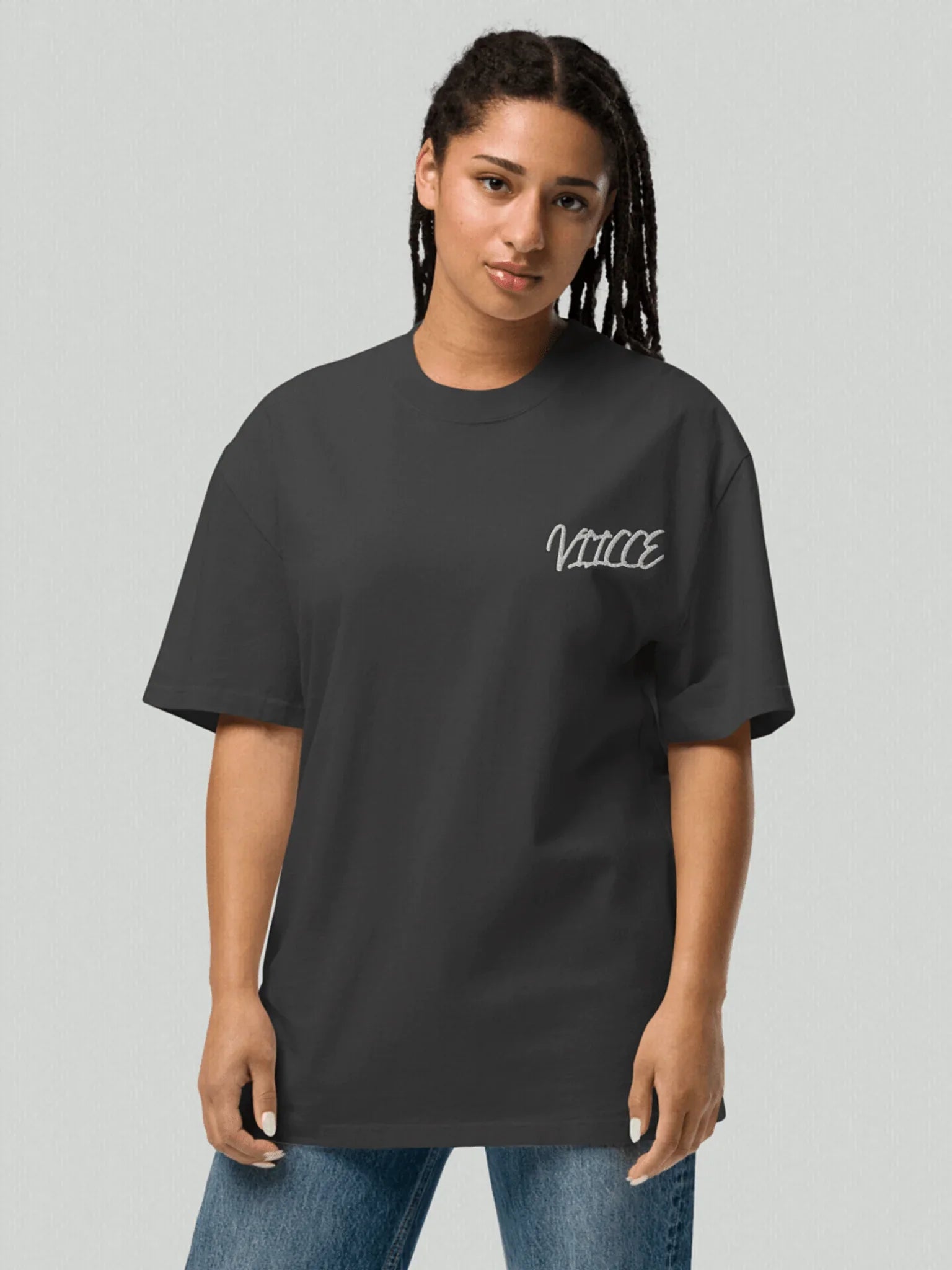 Female model wearing a charcoal gray washed oversized VIICCE T-shirt with logo on the chest